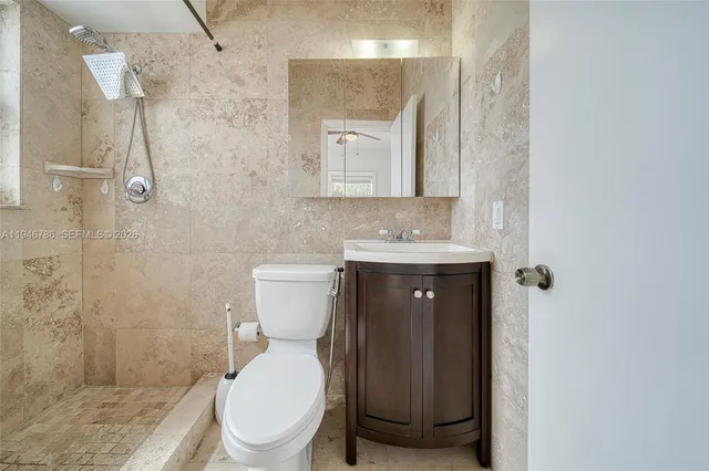 a bathroom with a toilet sink and shower
