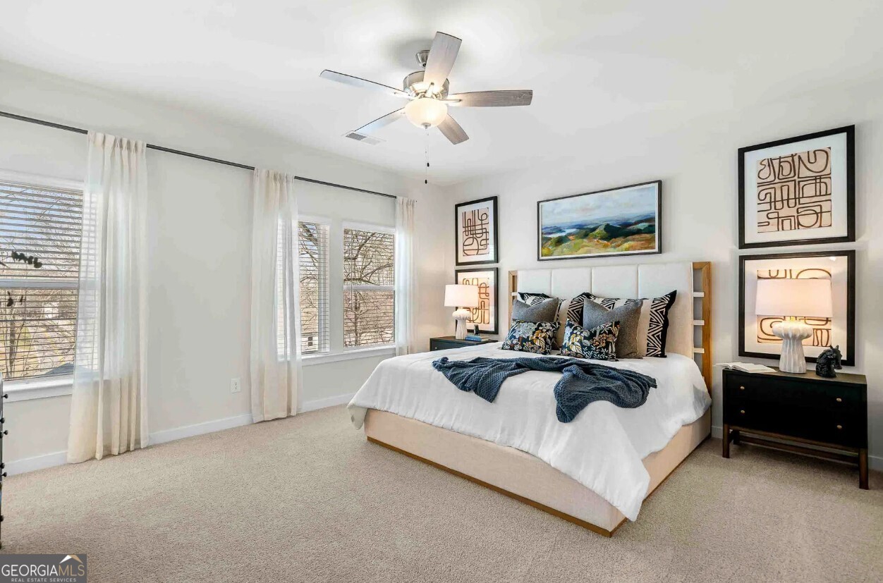 1450 Peachtree Industrial Boulevard, Unit 5109C Sugar Hill, GA 30518 - Photo 11 of 30 a spacious bedroom with a bed a couch and large window