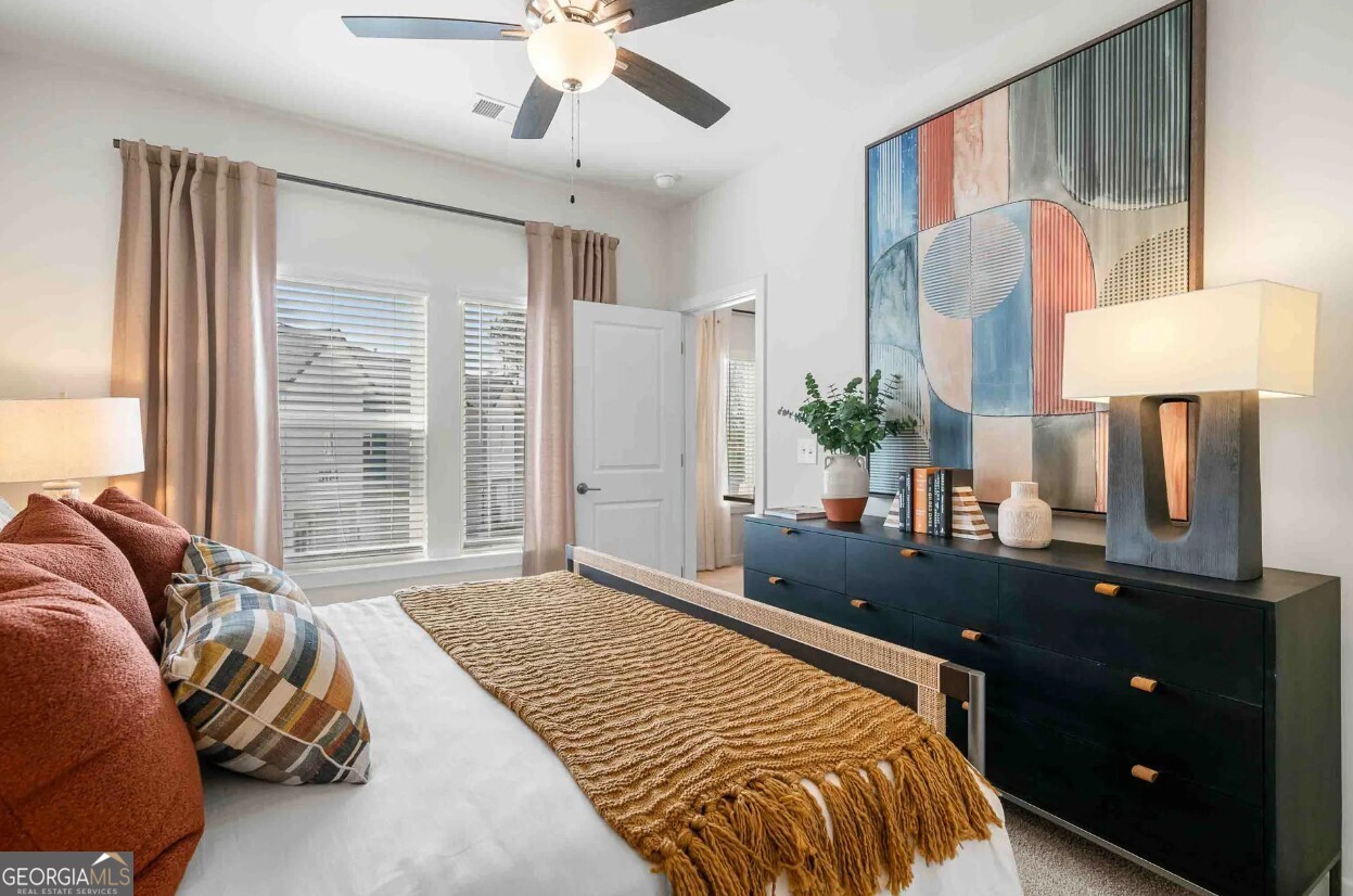 1450 Peachtree Industrial Boulevard, Unit 5109C Sugar Hill, GA 30518 - Photo 12 of 30 a bedroom with a bed lamps and table