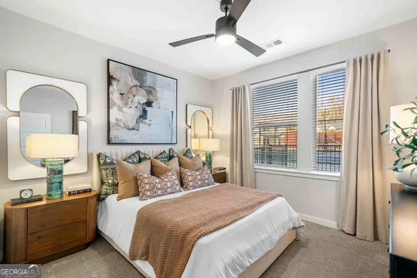 a bedroom with a bed and a painting on the wall