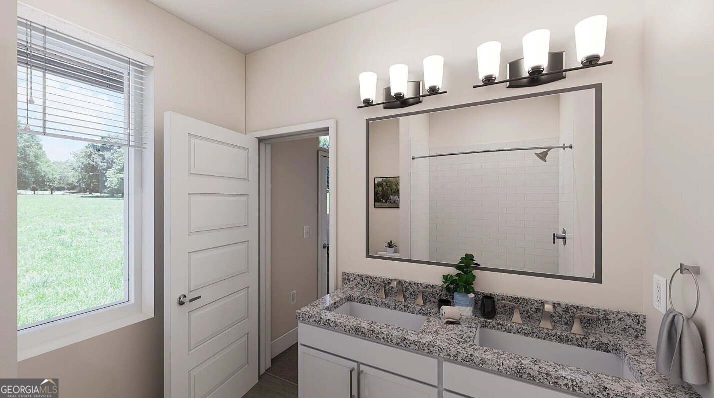 1450 Peachtree Industrial Boulevard, Unit 5109C Sugar Hill, GA 30518 - Photo 17 of 30 a bathroom with a granite countertop sink and a mirror