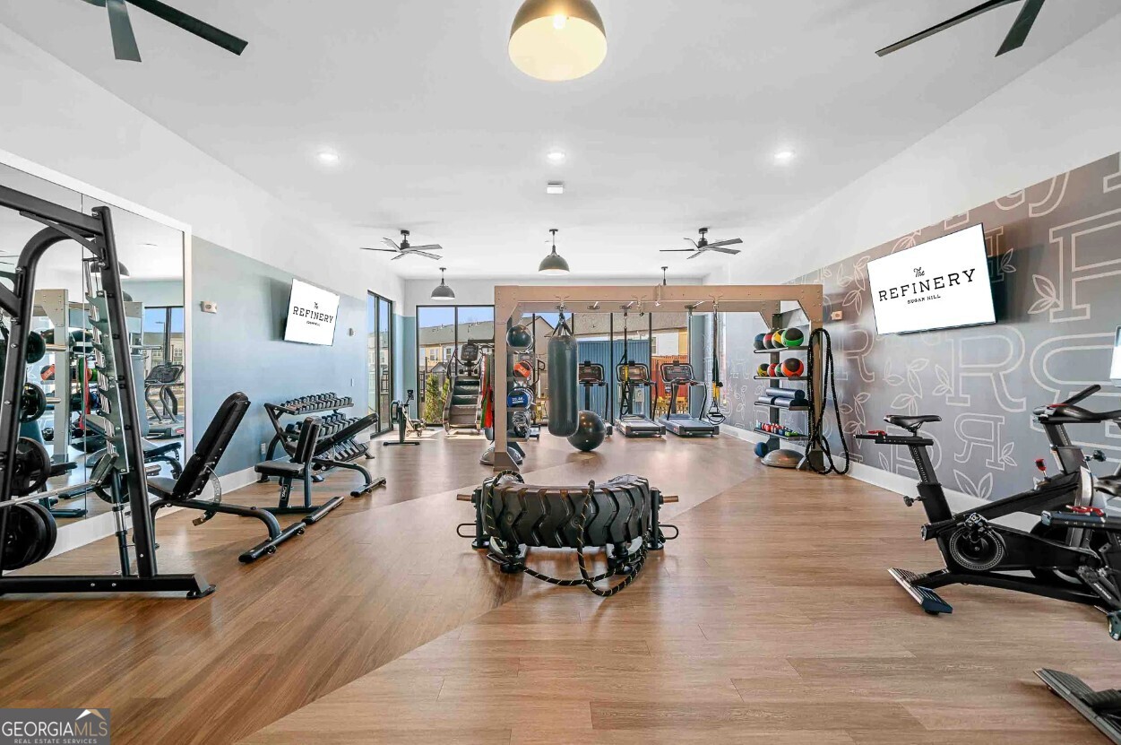 1450 Peachtree Industrial Boulevard, Unit 5109C Sugar Hill, GA 30518 - Photo 21 of 30 a view of a room with gym equipment and large windows