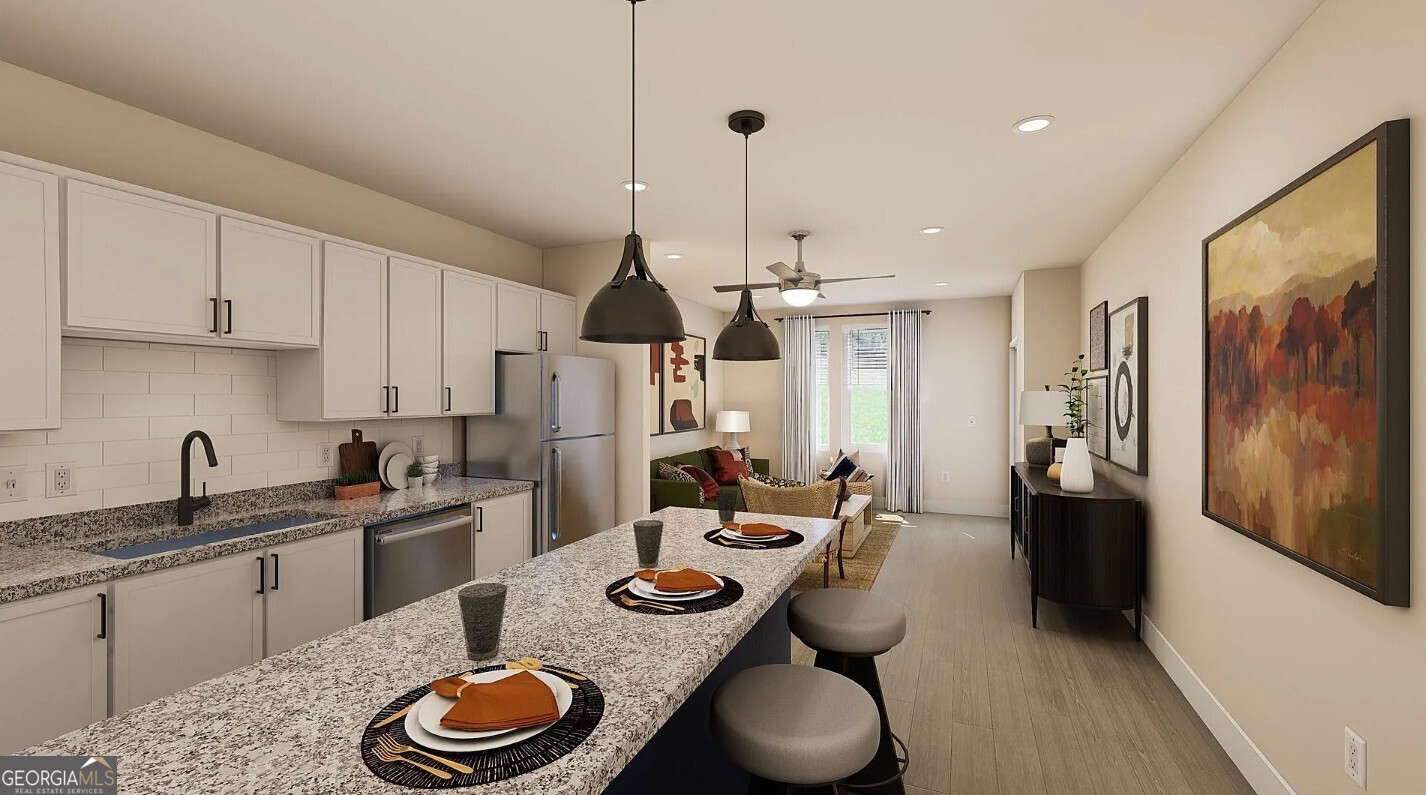 1450 Peachtree Industrial Boulevard, Unit 5109C Sugar Hill, GA 30518 - Photo 3 of 30 a kitchen with stainless steel appliances granite countertop a sink and a refrigerator