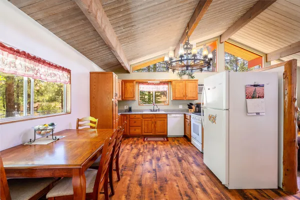 a kitchen with a table chairs refrigerator and sink