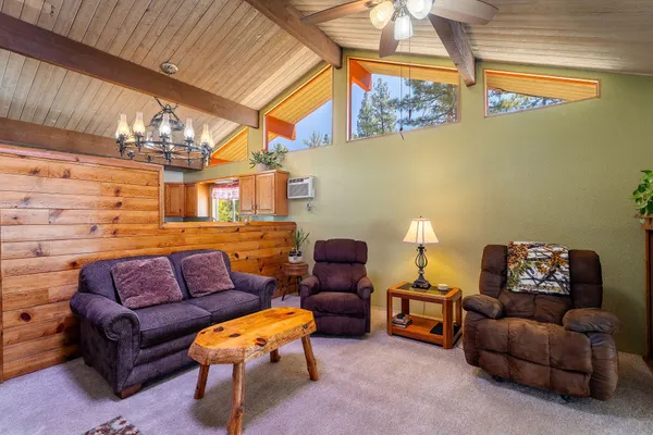 a living room with furniture a couch and a window