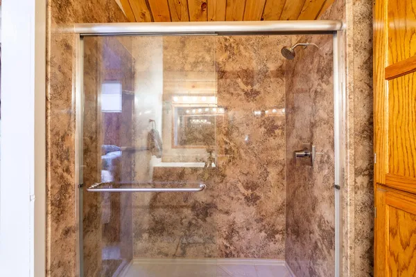 a bathroom with a glass shower door
