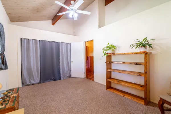 a view of room with hardwood floor and ceiling fan
