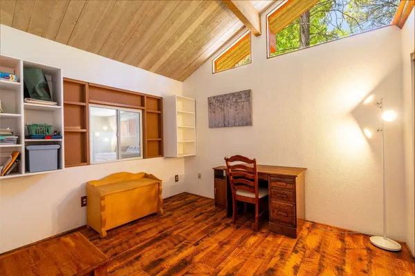 a bedroom with a bed and a desk
