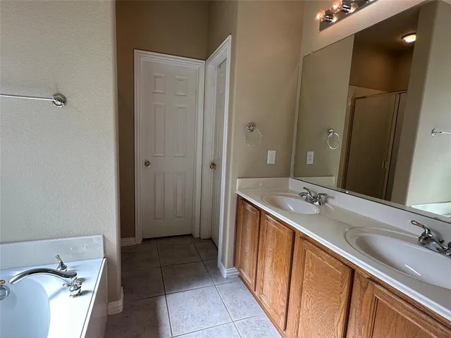a bathroom with a double vanity sink and mirror