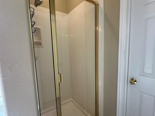 a bathroom with a glass shower door