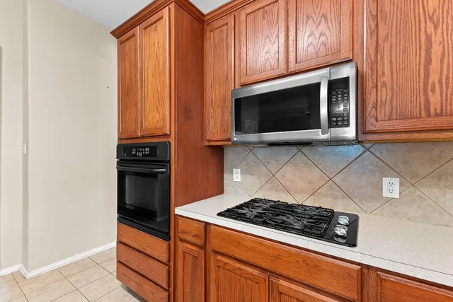 a stove top oven sitting inside of a kitchen