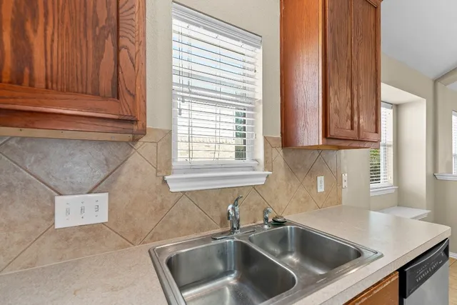 a kitchen with granite countertop a sink and a window