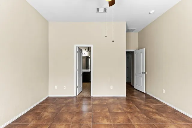 a view of an empty room with a kitchen