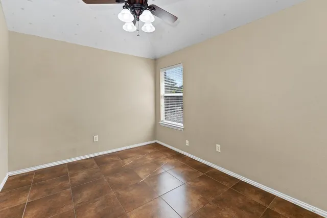 a view of a room with a window and ceiling fan