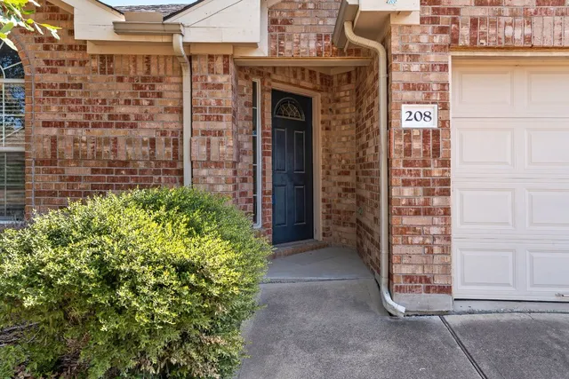 a front view of a building with a garden