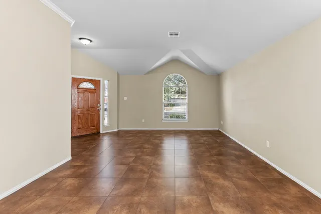 an empty room with windows and closet