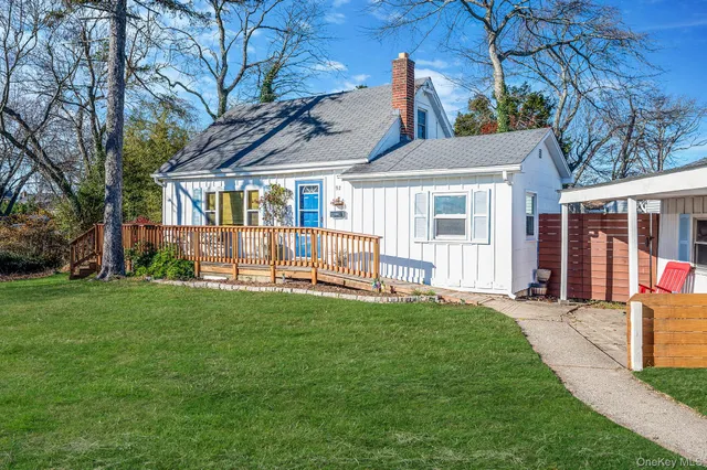 a view of a house with a yard and sitting area