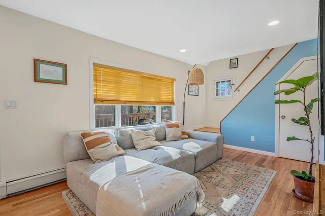 a living room with furniture and floor to ceiling window