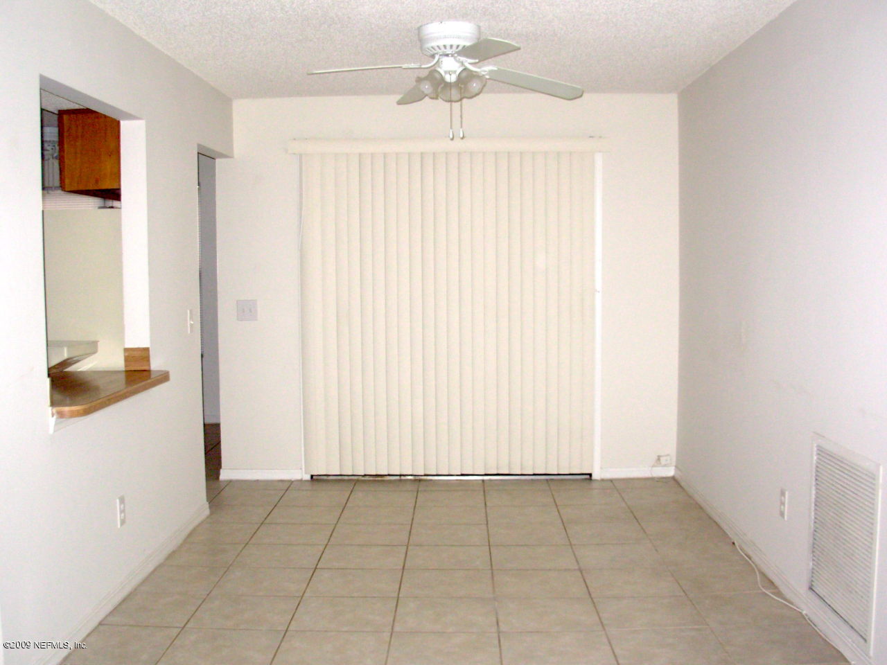 2107 Cornell Road Middleburg, FL 32068 - Photo 4 of 11 an empty room with windows and cabinet