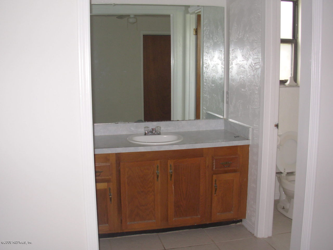 2107 Cornell Road Middleburg, FL 32068 - Photo 7 of 11 a bathroom with a sink and a mirror