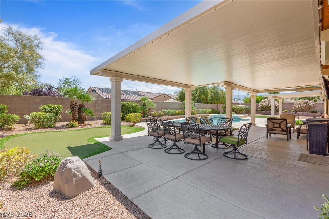 8431 Durango Ranch Court Las Vegas, NV 89113 - Photo 37 of 49 This spacious covered patio offers ample outdoor living, featuring a putting green and a sparkling pool.
