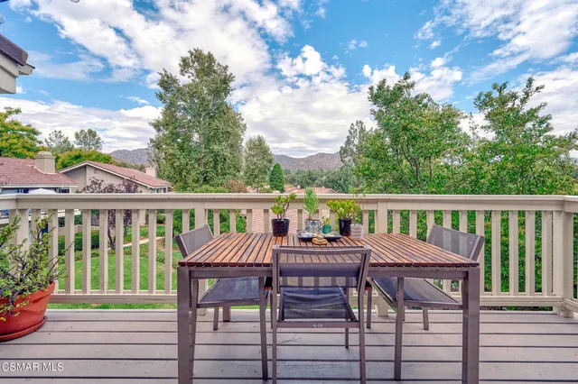 a view of a chairs and table in the balcony