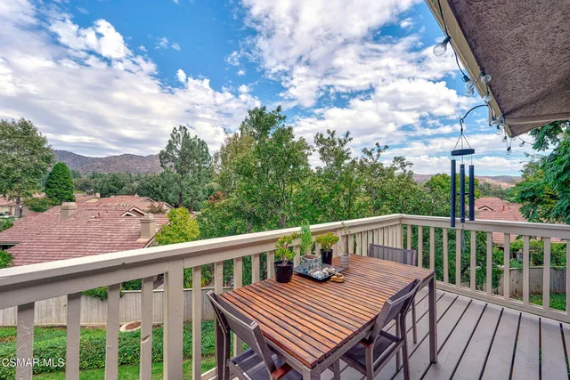 a view of a deck with wooden floor and barbeque oven