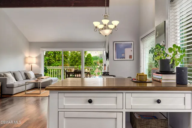 a kitchen with stainless steel appliances granite countertop wooden cabinets a stove a sink and a large window