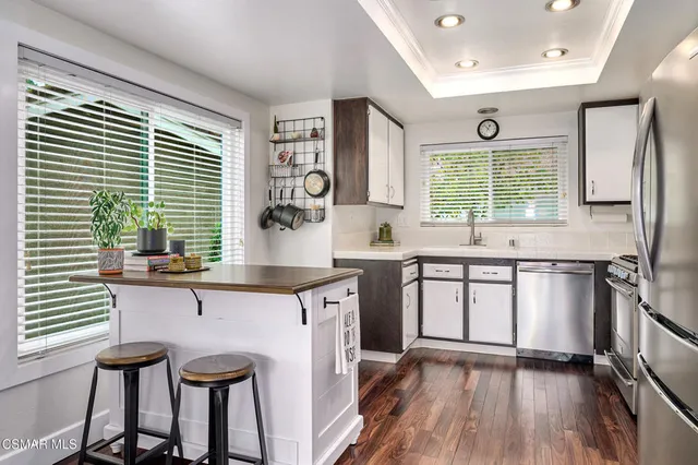 a kitchen with stainless steel appliances granite countertop a stove and a sink