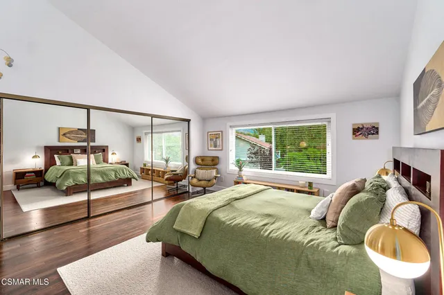 a bedroom with a bed and a lamp on table