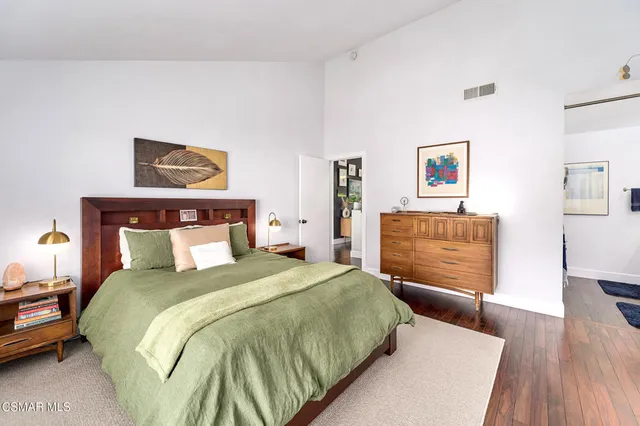 a bedroom with a bed and a bookshelf