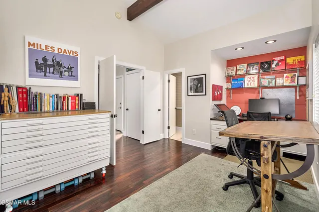 a living room with furniture a fireplace and a floor to ceiling window