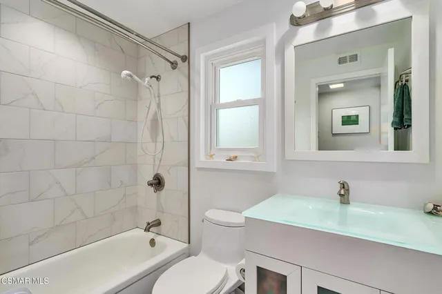 a bedroom with bed and a window