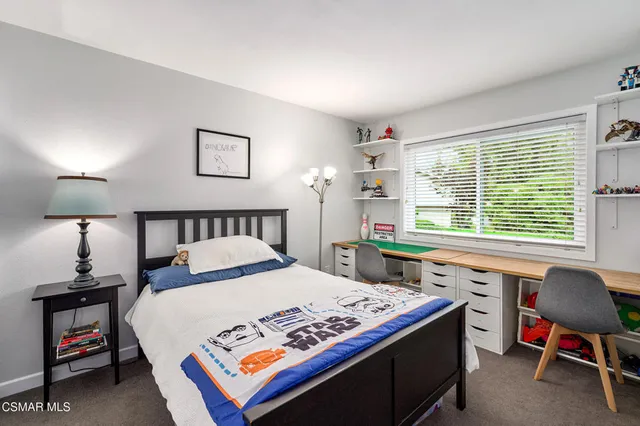 a view of backyard with swimming pool and sitting area