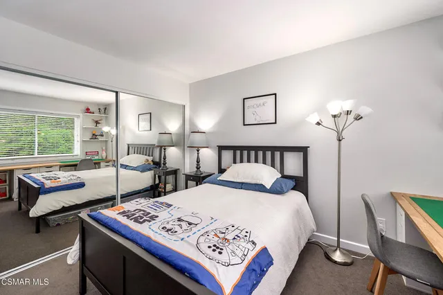 a front view of a house with a yard and green space