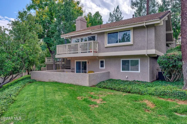 a aerial view of a house with swimming pool next to a yard
