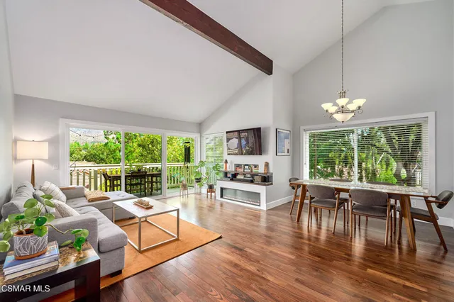 a living room with furniture dining table and a large window