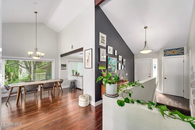 a dining room with furniture a chandelier and wooden floor