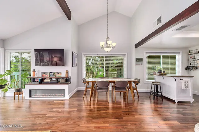 a view of a dining room with furniture window and wooden floor