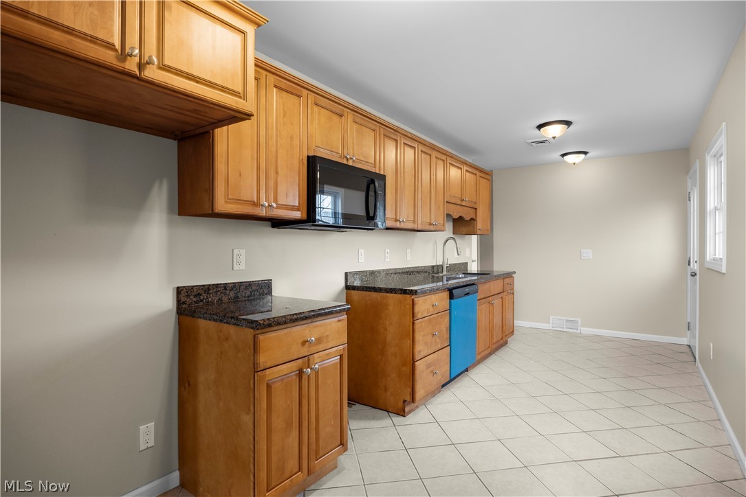 12452 Island Road Grafton, OH 44044 - Photo 13 of 39 Kitchen featuring wood finish cabinets, black microwave, light tile patterned floors, and dishwasher