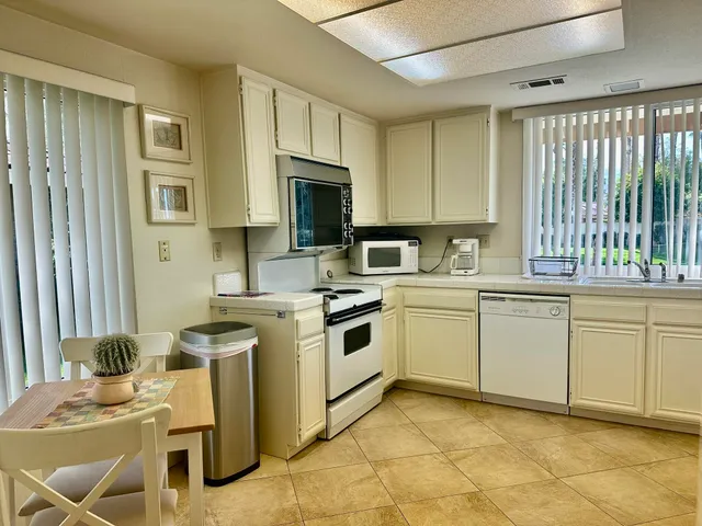 a kitchen with a stove a sink and a refrigerator