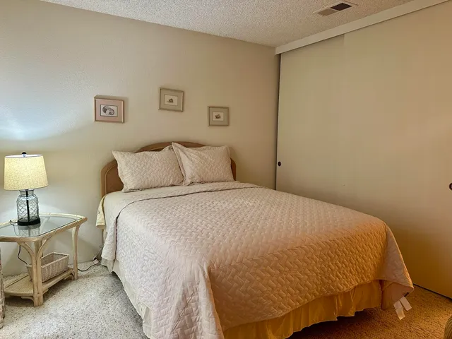 a bedroom with a bed and lamp