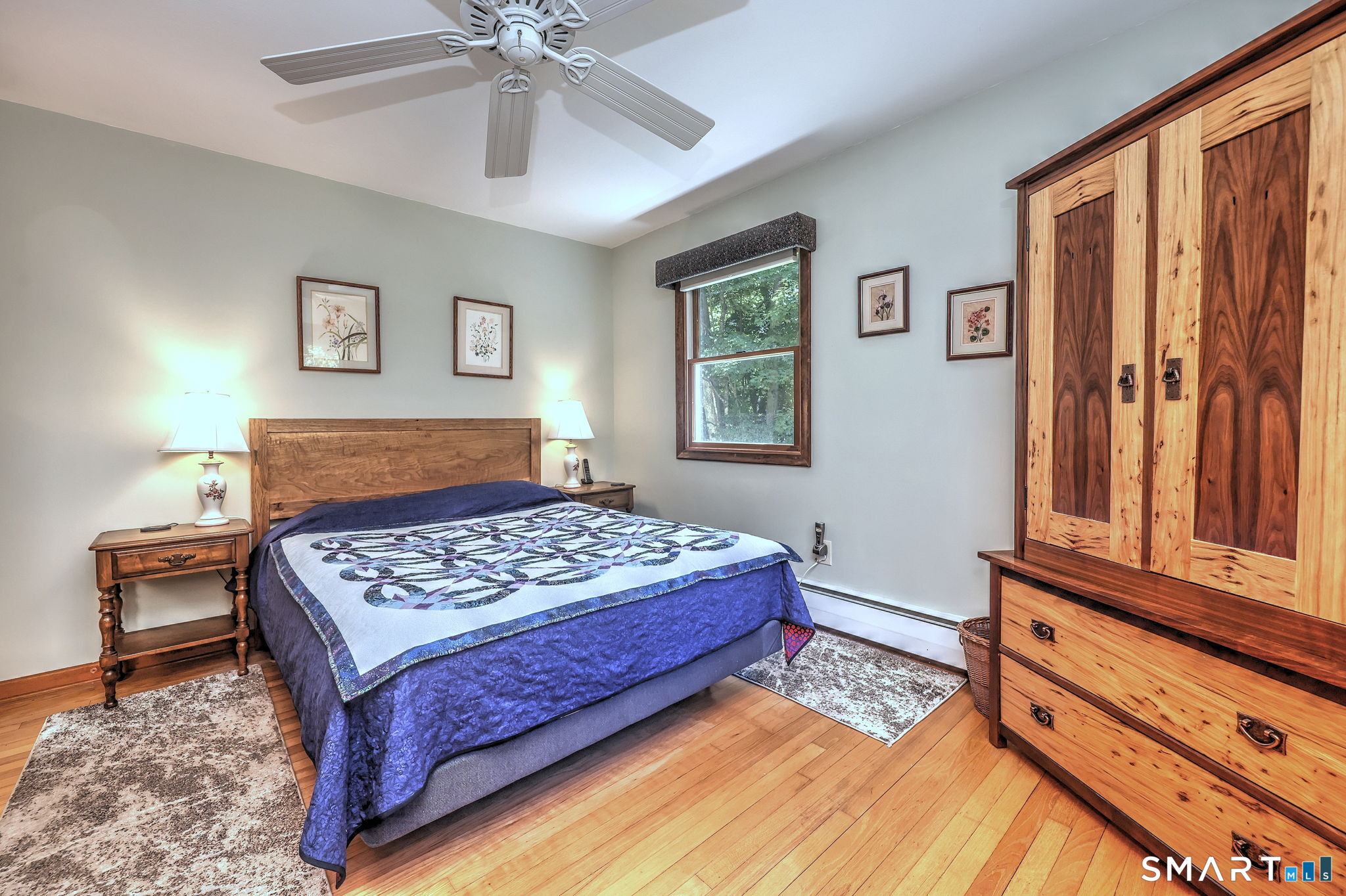 25 Mountain View Road Bethany, CT 06524 - Photo 15 of 27 Primary bedroom complete with hardwood floors, ceiling fan and multiple windows to let the fresh air and natural light in.