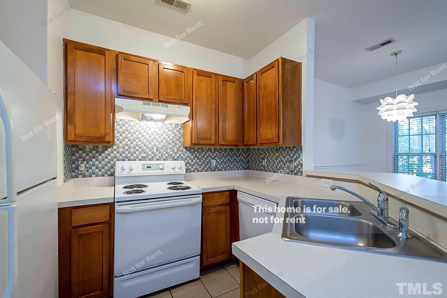 2625 Broad Oaks Place Raleigh, NC 27603 - Photo 2 of 14 a kitchen with a sink a stove and cabinets