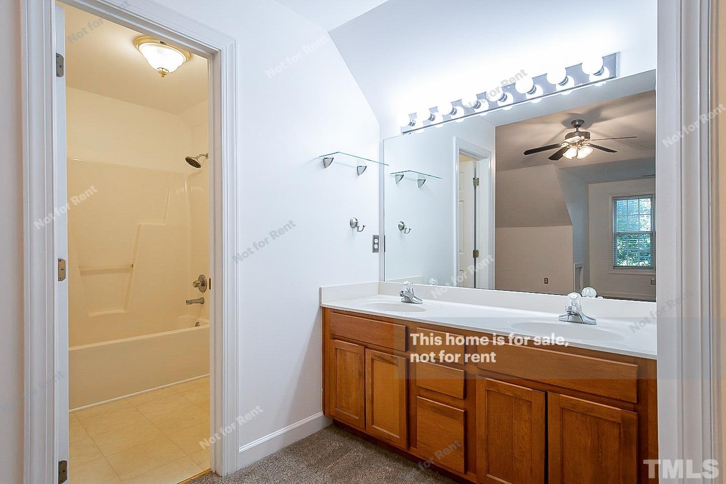 2625 Broad Oaks Place Raleigh, NC 27603 - Photo 12 of 14 a bathroom with a granite countertop sink a mirror and a shower