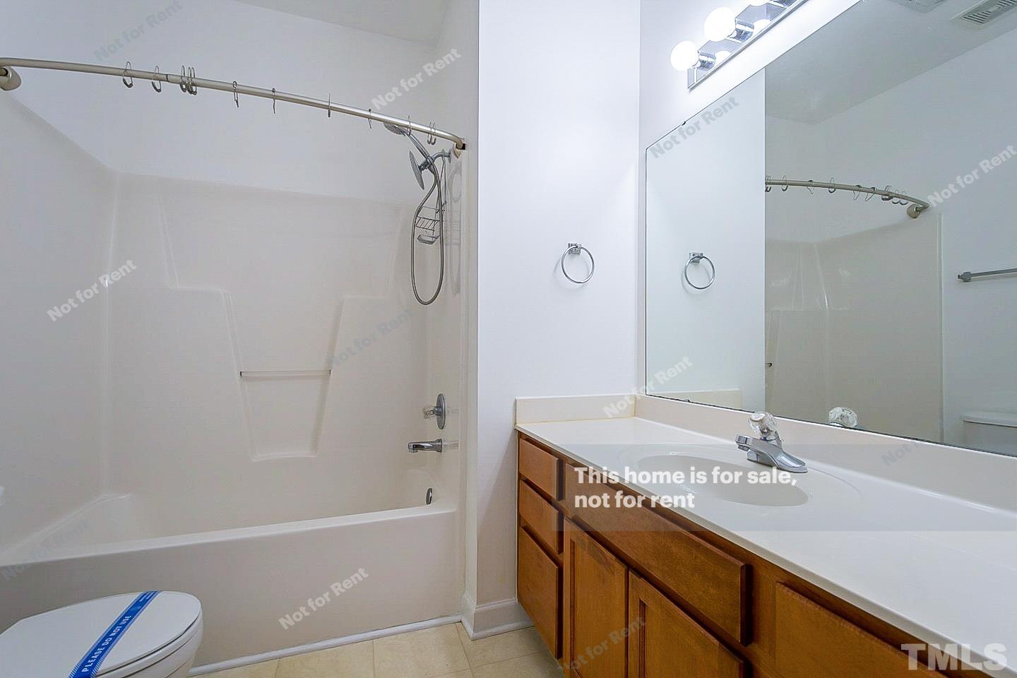 2625 Broad Oaks Place Raleigh, NC 27603 - Photo 4 of 14 a bathroom with a granite countertop sink a toilet and shower