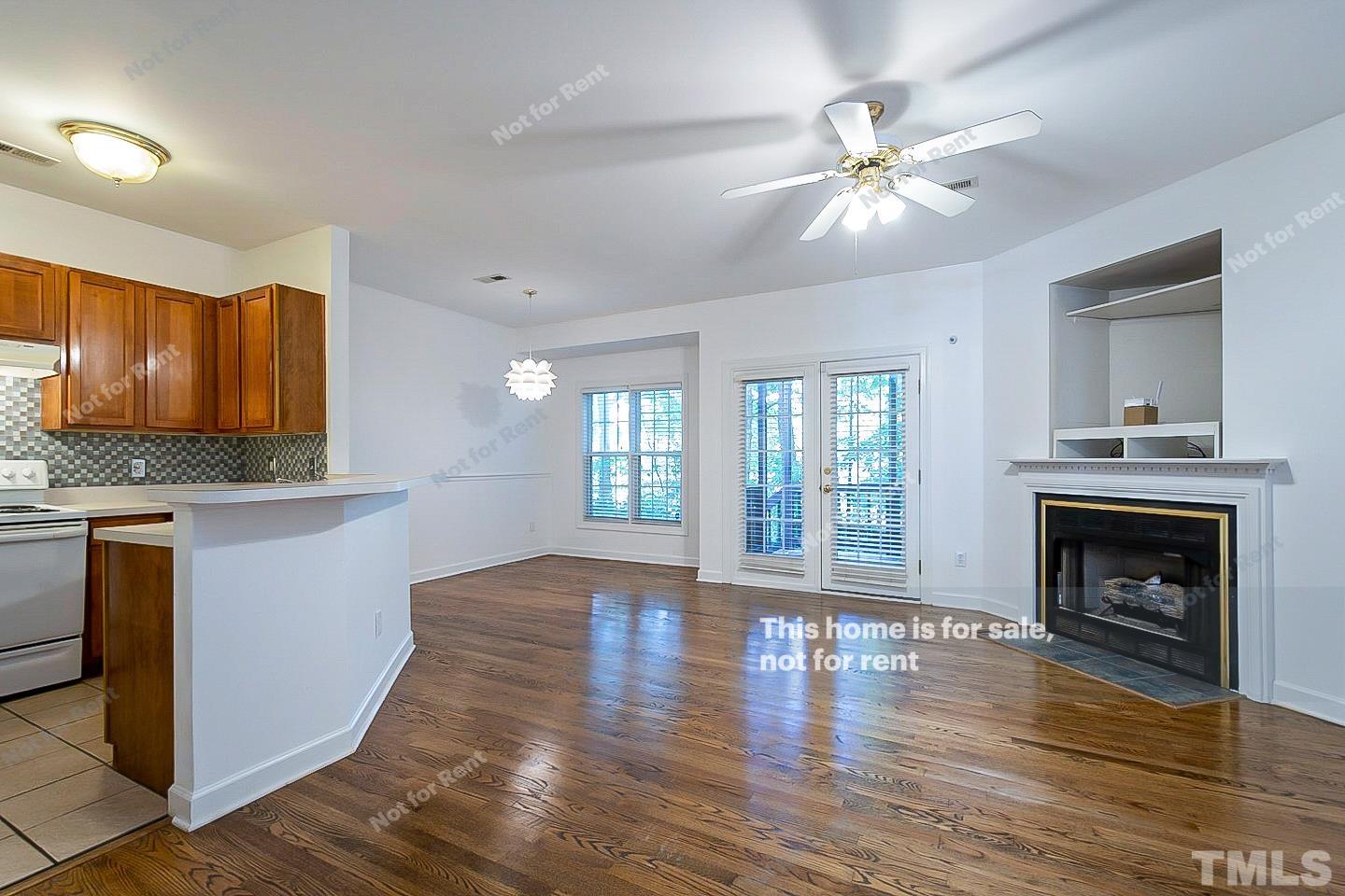 2625 Broad Oaks Place Raleigh, NC 27603 - Photo 7 of 14 a view of an empty room with wooden floor and a fireplace