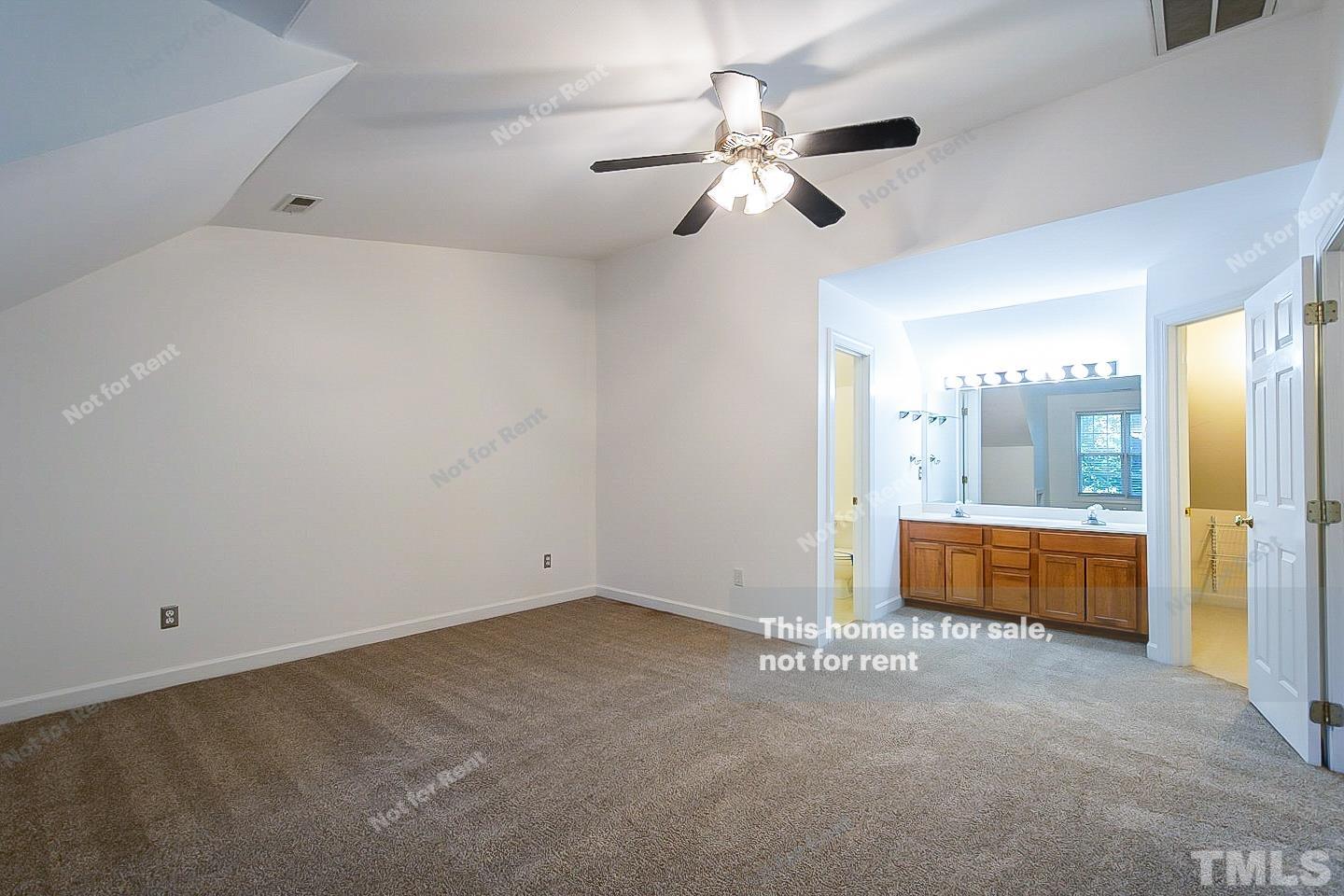 2625 Broad Oaks Place Raleigh, NC 27603 - Photo 10 of 14 an empty room with chandelier fan and kitchen view