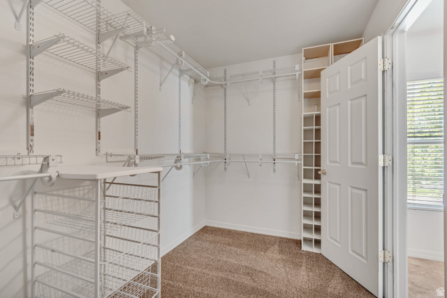 546 Wheatridge Road Tooele, UT 84074 - Photo 26 of 49 Master walk-in closet featuring built-in wire shelving w/ adjustable hanging rods