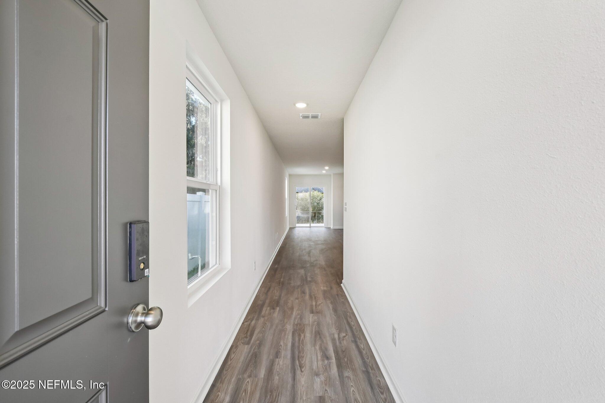 3407 Mildred Way Jacksonville, FL 32254 - Photo 13 of 38 a view of a hallway with wooden floor and a bathroom